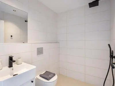 a white bathroom with a sink and a toilet at Astra boutique suites at Agia Marina Beach in Agia Marina Nea Kydonias