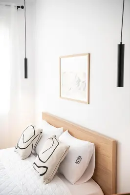 a bedroom with a bed with white sheets and pillows at Astra boutique suites at Agia Marina Beach in Agia Marina Nea Kydonias