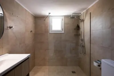 a bathroom with a shower and a sink at MV Living - Residence in Chania Town