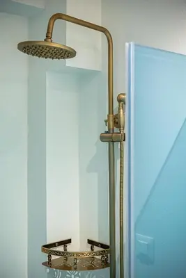 a bathroom with a mirror and a light fixture at Villaspo Homes in Chania Town