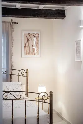 a bedroom with a metal bed in a white wall at Villaspo Homes in Chania Town