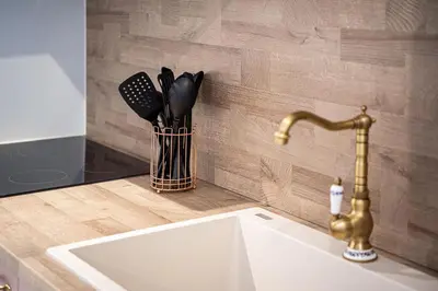 a kitchen counter with a sink and a faucet at Villaspo Homes in Chania Town