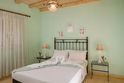 a bedroom with a bed with white sheets and pillows at Seaview Villa Sofia ' Top destination ' in Kissamos