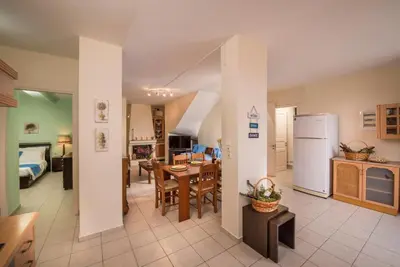 a living room with a kitchen and a dining room at Seaview Villa Sofia ' Top destination ' in Kissamos