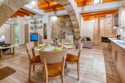 a kitchen and dining room with a table and chairs at Petros Luxury Traditional House - Villa in Kissamos