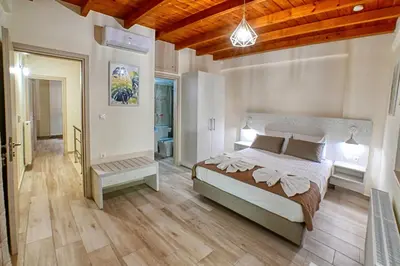 a bedroom with a large bed and a wooden ceiling at Petros Luxury Traditional House - Villa in Kissamos