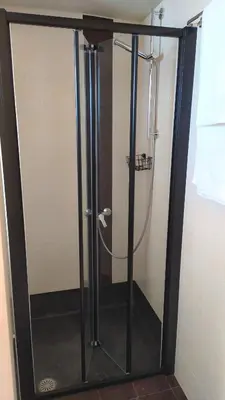 a shower with a glass door in a bathroom at GioDriana cozy studio in Agia Marina Nea Kydonias