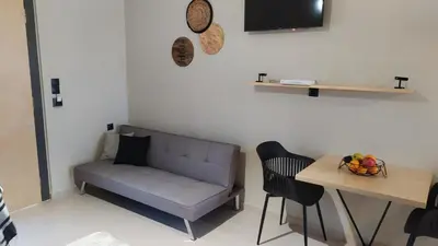 a living room with a couch and a table at GioDriana cozy studio in Agia Marina Nea Kydonias