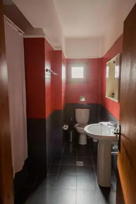 a bathroom with a white sink and a toilet at Retreat Homes Apokoronas in Douliana