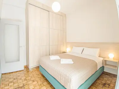 a bedroom with a bed with two towels on it at Fully renovated apartment in the city centre with roof garden! 3 minutes from the bus station and 6 minutes from the old town in Chania Town