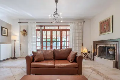 a living room with a couch and a fireplace at Skine Dream Villa in Chania Town