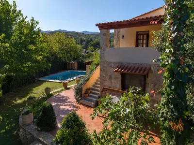an external view of a house with a swimming pool at Skine Dream Villa in Chania Town
