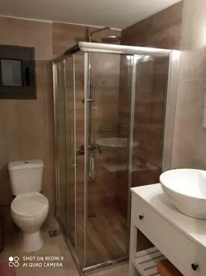 a bathroom with a shower and a toilet and a sink at nafsikacottagehouse in Kissamos