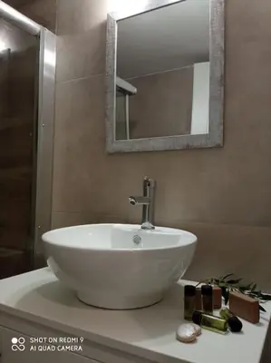 a white sink on a counter in a bathroom at nafsikacottagehouse in Kissamos