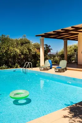 a swimming pool with two lounge chairs and a swimming pool at Villa Vallia - Villa Marina in Kato Galatas