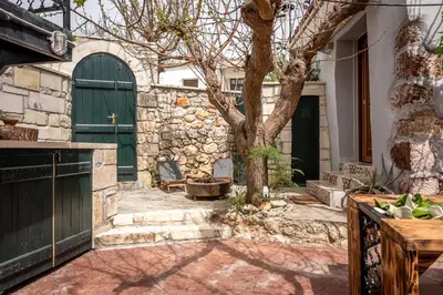 a tree in front of a building with a door at Villa Armenus, private pool, garden, BBQ in Chania Town