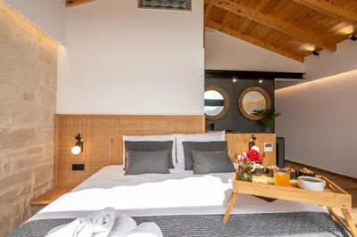 a bedroom with a large bed and a wooden table at Villa Armenus, private pool, garden, BBQ in Chania Town