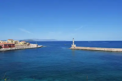 a lighthouse in the middle of a large body of water at Gallery Art Apartment Chania Crete in Chania Town