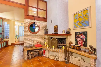 a living room with a stone fireplace in a house at Loft Art Gallery, Chania, Crete in Chania Town