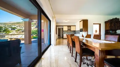 a kitchen and dining room with a table and chairs at Grand Olympia,Luxury, spacious indoor&outdoor area in Kissamos