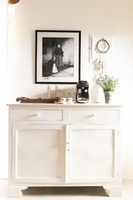 a white console table with a picture on the wall at Feána Home by 8essentially in Psathoyiánnos