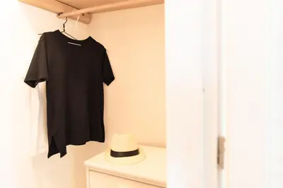 a black shirt is hanging on a wall at Feána Home by 8essentially in Psathoyiánnos