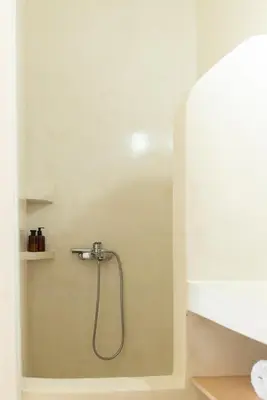 a shower with a shower head in a bathroom at Feána Home by 8essentially in Psathoyiánnos