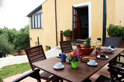 a wooden table with a bowl of fruit on a patio at Villa Palma in Maleme
