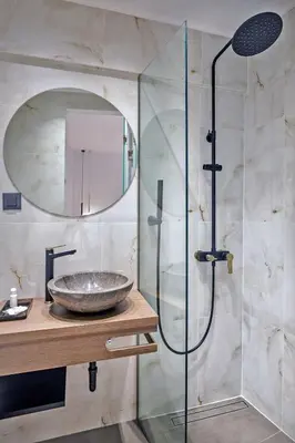 a bathroom with a sink and a glass shower at Arch 4 Luxury Living in Chania Town