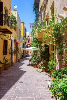 an alley with plants and tables and buildings at Arch 4 Luxury Living in Chania Town