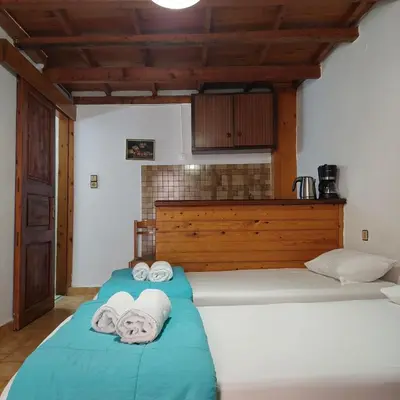 a bedroom with a bed with towels on it at Guesthouse Chryssoula in Chania Town