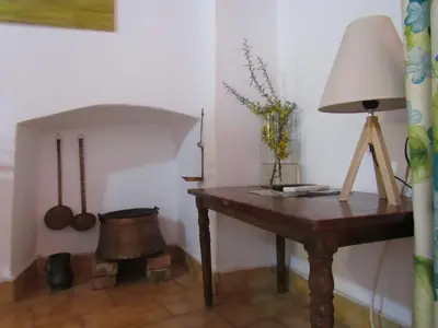 a room with a table with a lamp and a mortar at Guesthouse Chryssoula in Chania Town