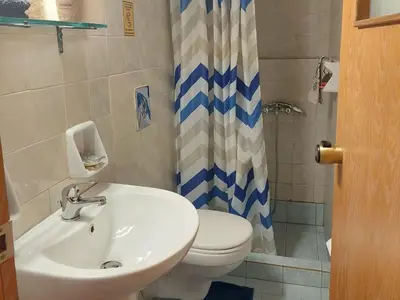 a bathroom with a white toilet and a sink at Guesthouse Chryssoula in Chania Town