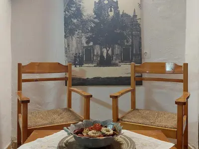 two chairs and a bowl of food on a table at Guesthouse Chryssoula in Chania Town