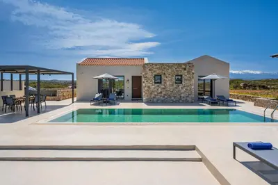 a villa with a swimming pool and a patio at Villa Afeidia in Tersanas