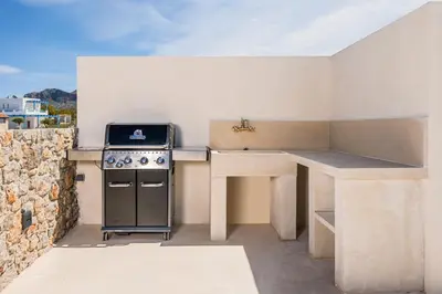 a kitchen with a stove and a counter top at Villa Afeidia in Tersanas