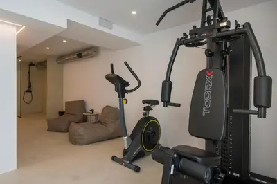 a room with a gym with two exercise bikes at Villa Afeidia in Tersanas