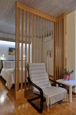 a bedroom with a bed and a chair in a room at Helianthi in Chania Town