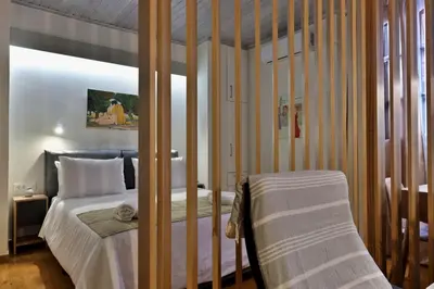 a bedroom with a bed with a wooden frame at Helianthi in Chania Town