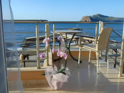a balcony with a table and chairs on a boat at Comfy Beachfront Litinas Casa with SeaView in Chania Town