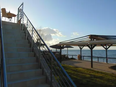 a set of stairs next to a beach with the ocean at Comfy Beachfront Litinas Casa with SeaView in Chania Town