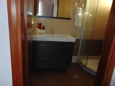a bathroom with a sink and a shower at Comfy Beachfront Litinas Casa with SeaView in Chania Town