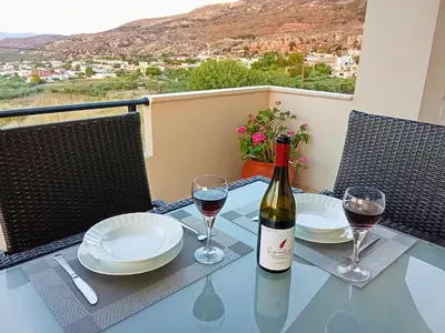 a table with a bottle of wine and two glasses at 