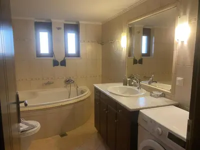 a bathroom with a tub and a toilet and a sink at 