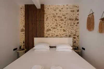 a bedroom with a white bed with two pillows at MV Living - Studio in Chania Town