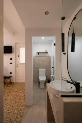 a bathroom with a toilet and a sink and a tub at MV Living - Studio in Chania Town