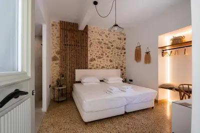 a bedroom with a white bed in a room at MV Living - Studio in Chania Town