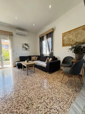 a living room with a couch and a table at ERIS House in Kissamos