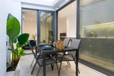 a dining room with a black table and chairs at Casa Del Mare Luxury Guest House in Chania Town