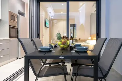 a dining room with a black table and chairs at Casa Del Mare Luxury Guest House in Chania Town